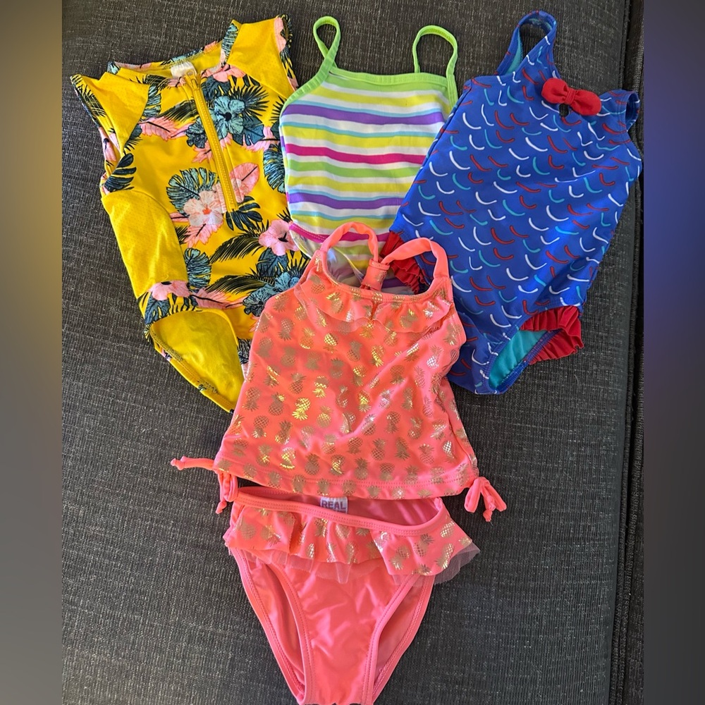 6 bathing suits. See last 2 photos for additional suits. size 18 months